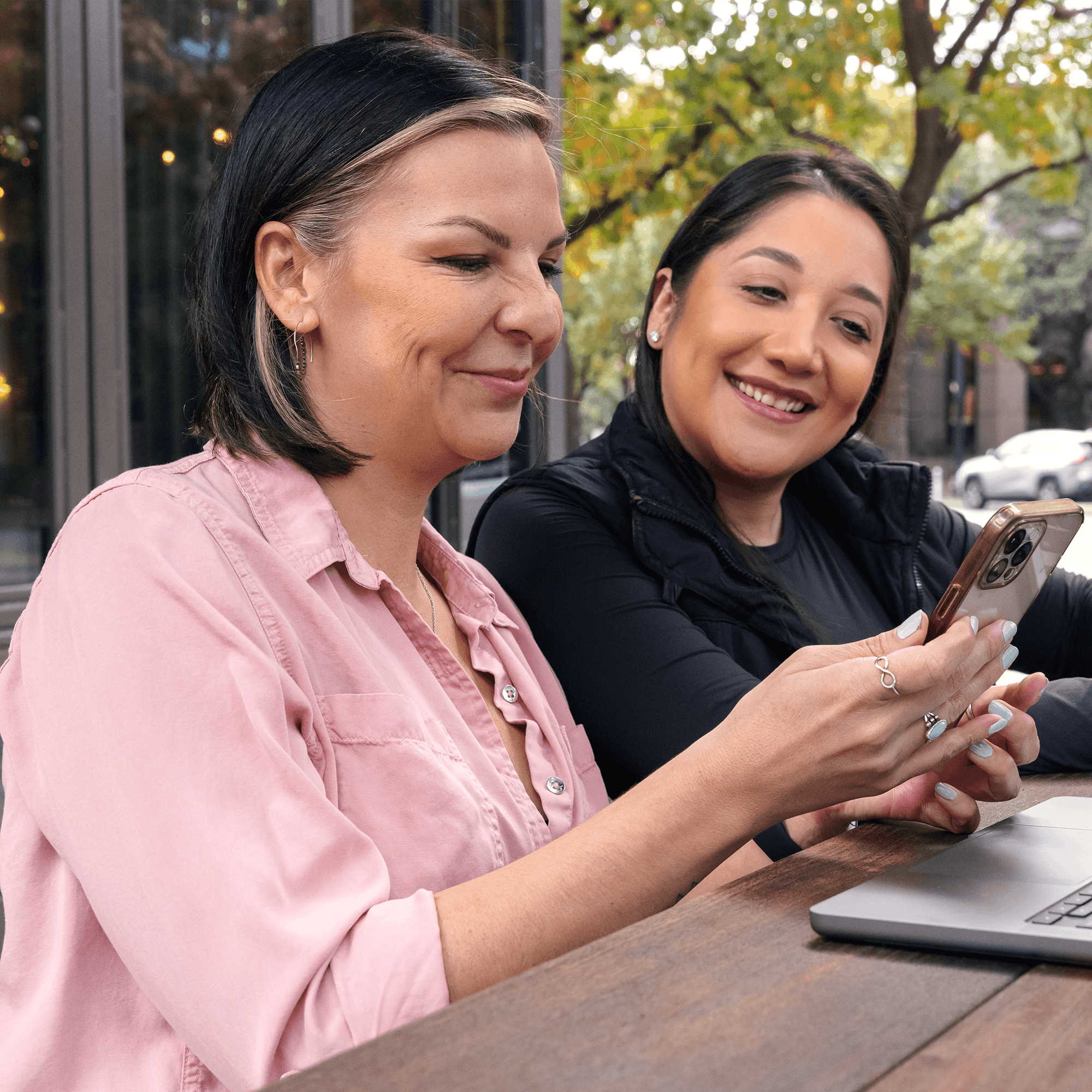 Two Medely employees together looking at mobile device