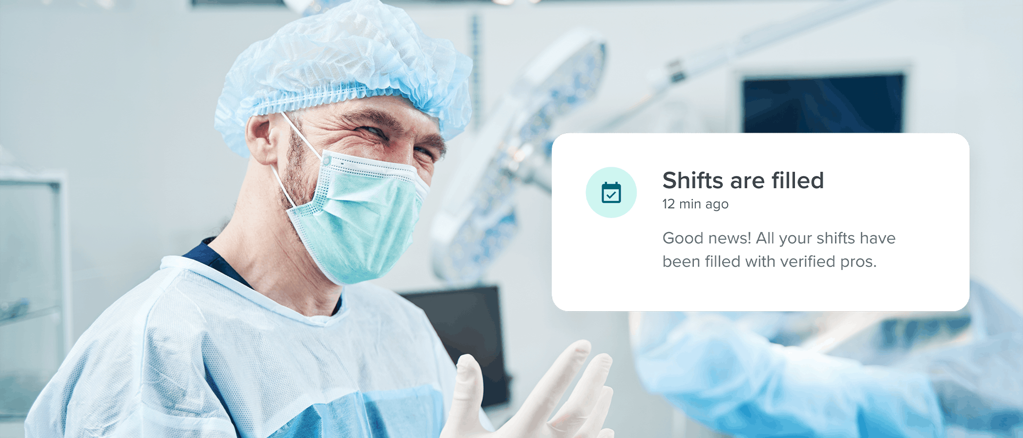 man in surgical outfit smiling in operating room with Medely's Surgery Center Staffing icon to the right