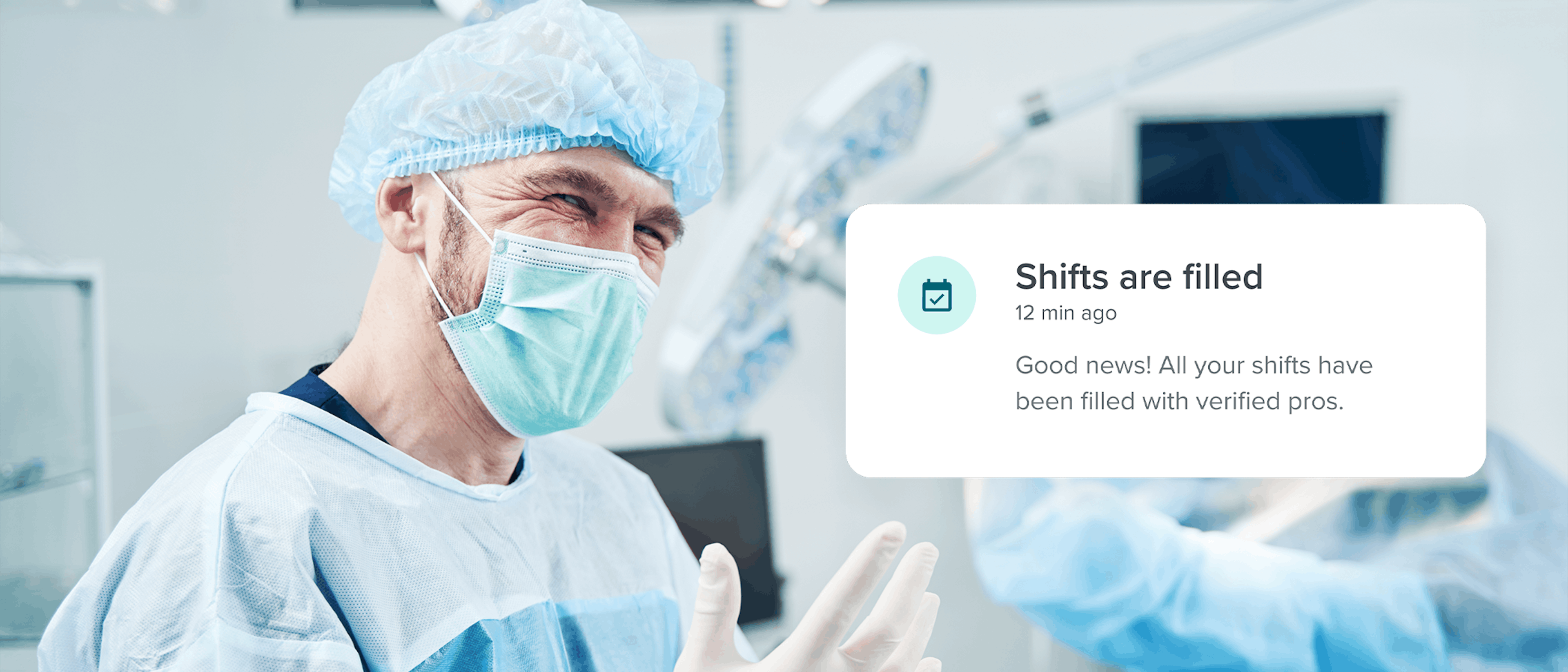 man in surgical outfit smiling in operating room
