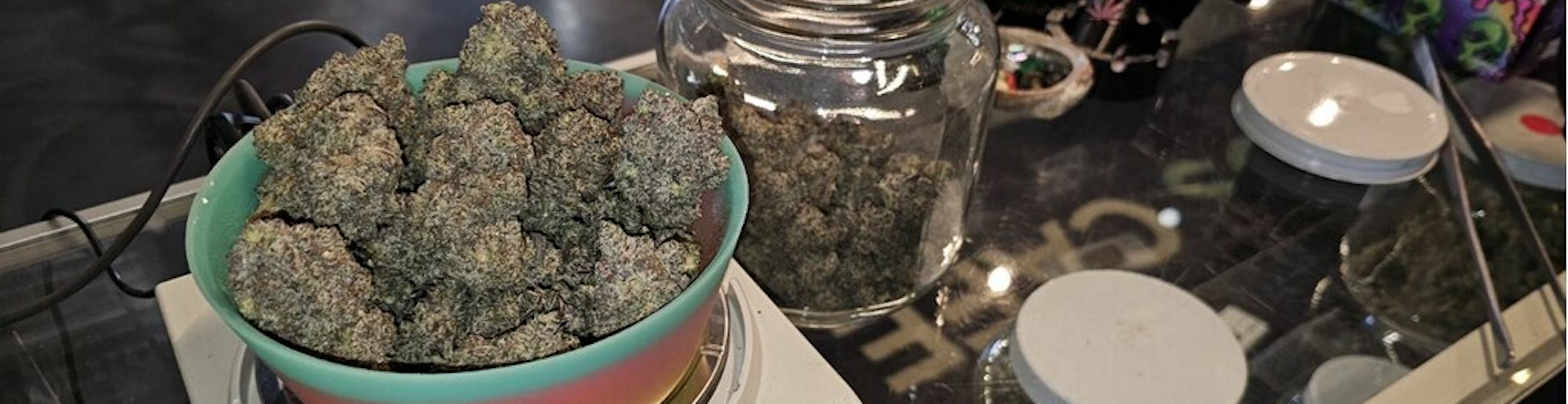 cannabis buds in a bowl on a digital scale