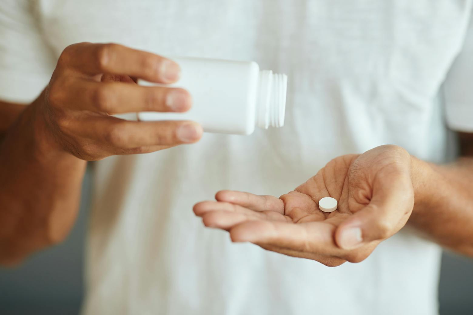 Person taking pill representing the Zantac cancer lawsuits.