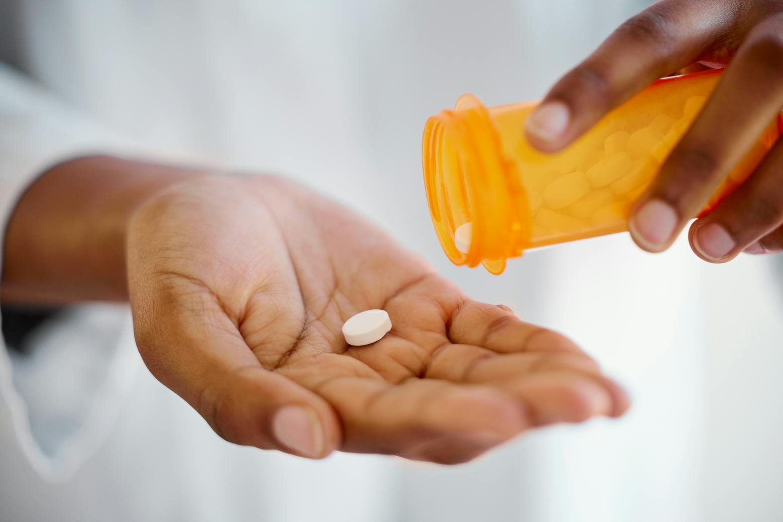 Image of a person taking prescription pills representing the Zantac trial delayed until July.