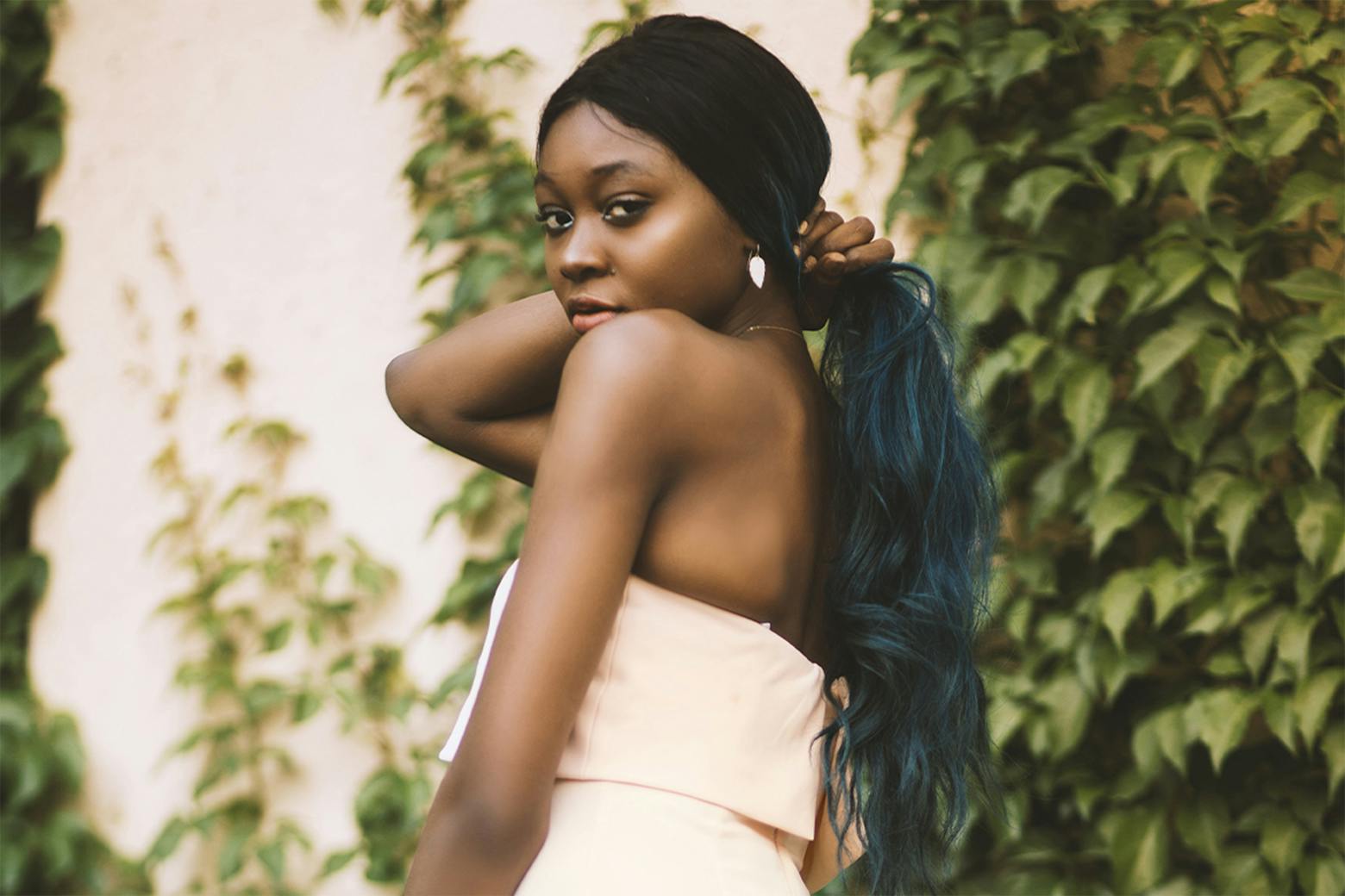 Photo of a woman holding her dyed hair, representing the cancer risk linked to hair dyes and straighteners.