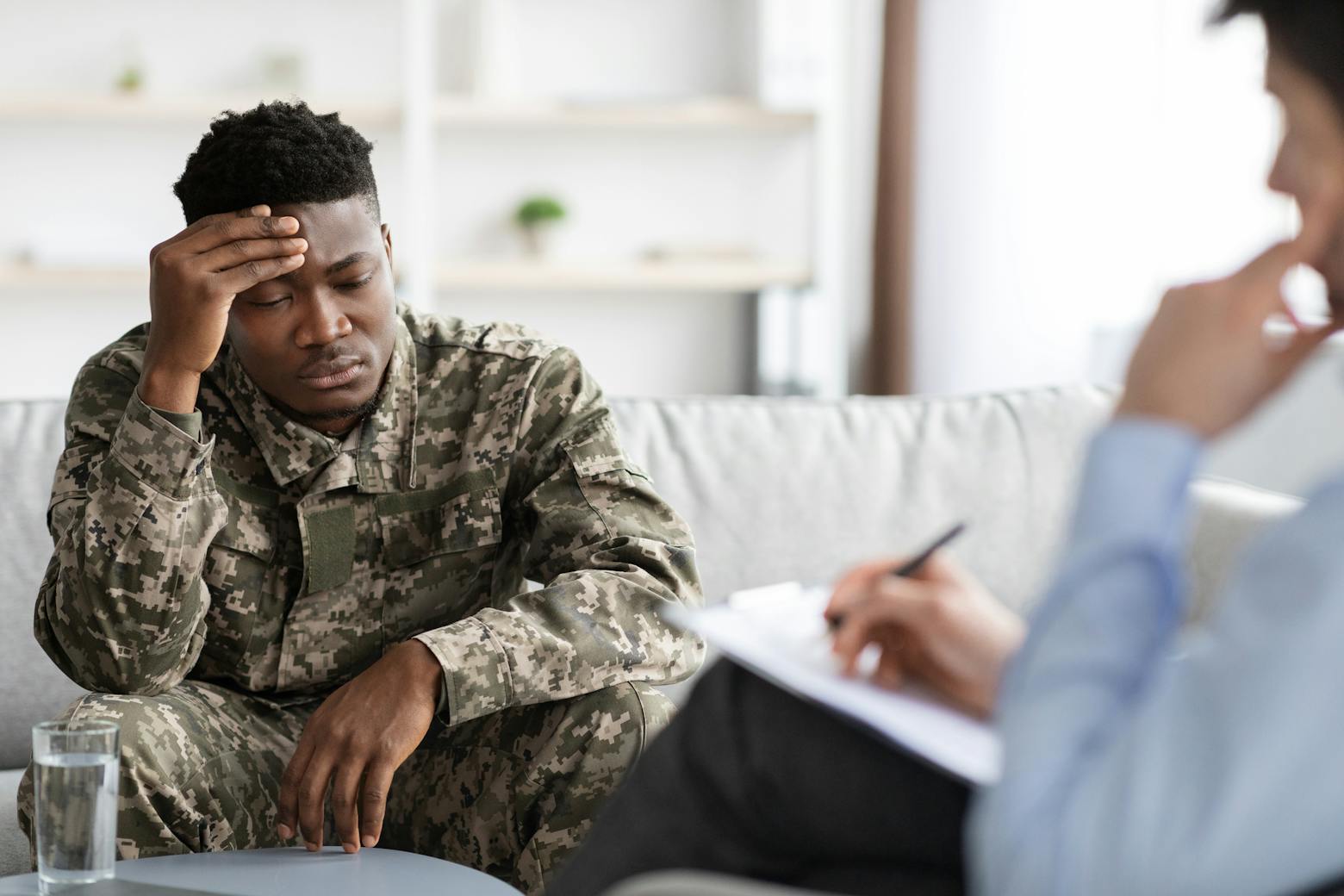 A military veteran talking to a doctor representing the 3M military earplugs allegedly causing hearing loss.