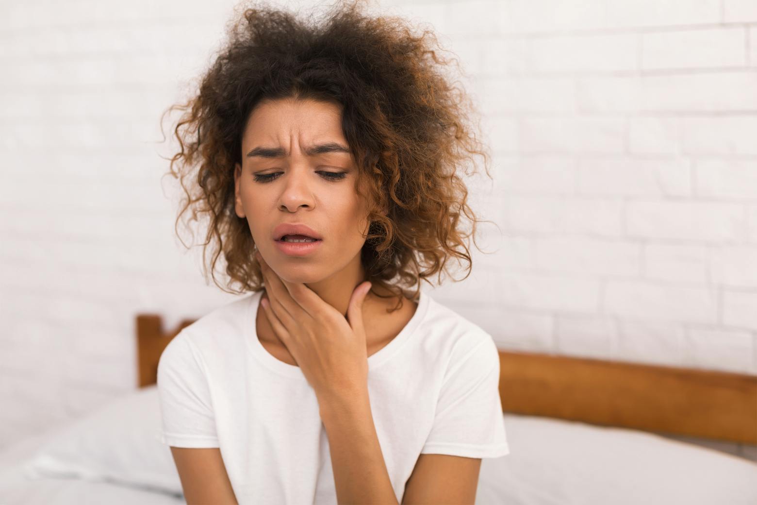 A stock image of a woman with heartburn, representing Zantac lawsuit consolidation in California.