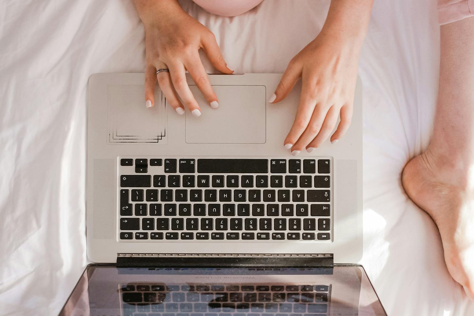 Woman on laptop reading MT weekly's latest topics on J&J Asbestos Settlement, EPA to Regulate PFAS.