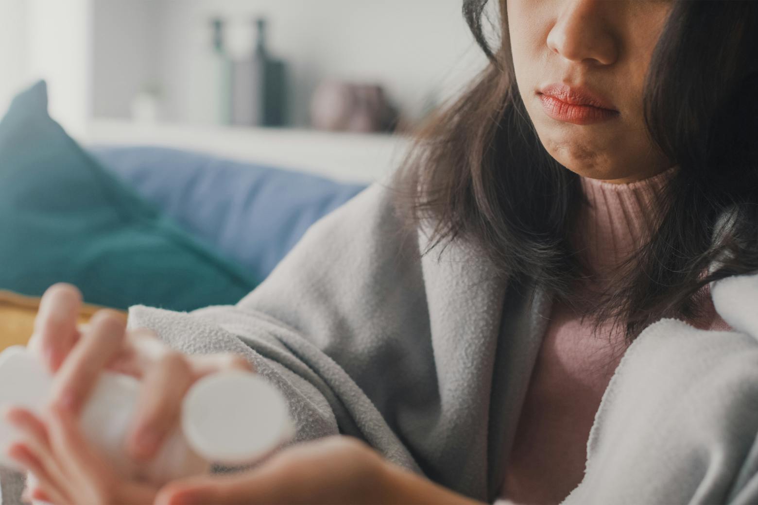 Image of a woman with a pill bottle representing the first Zantac lawsuits taking place in CA.