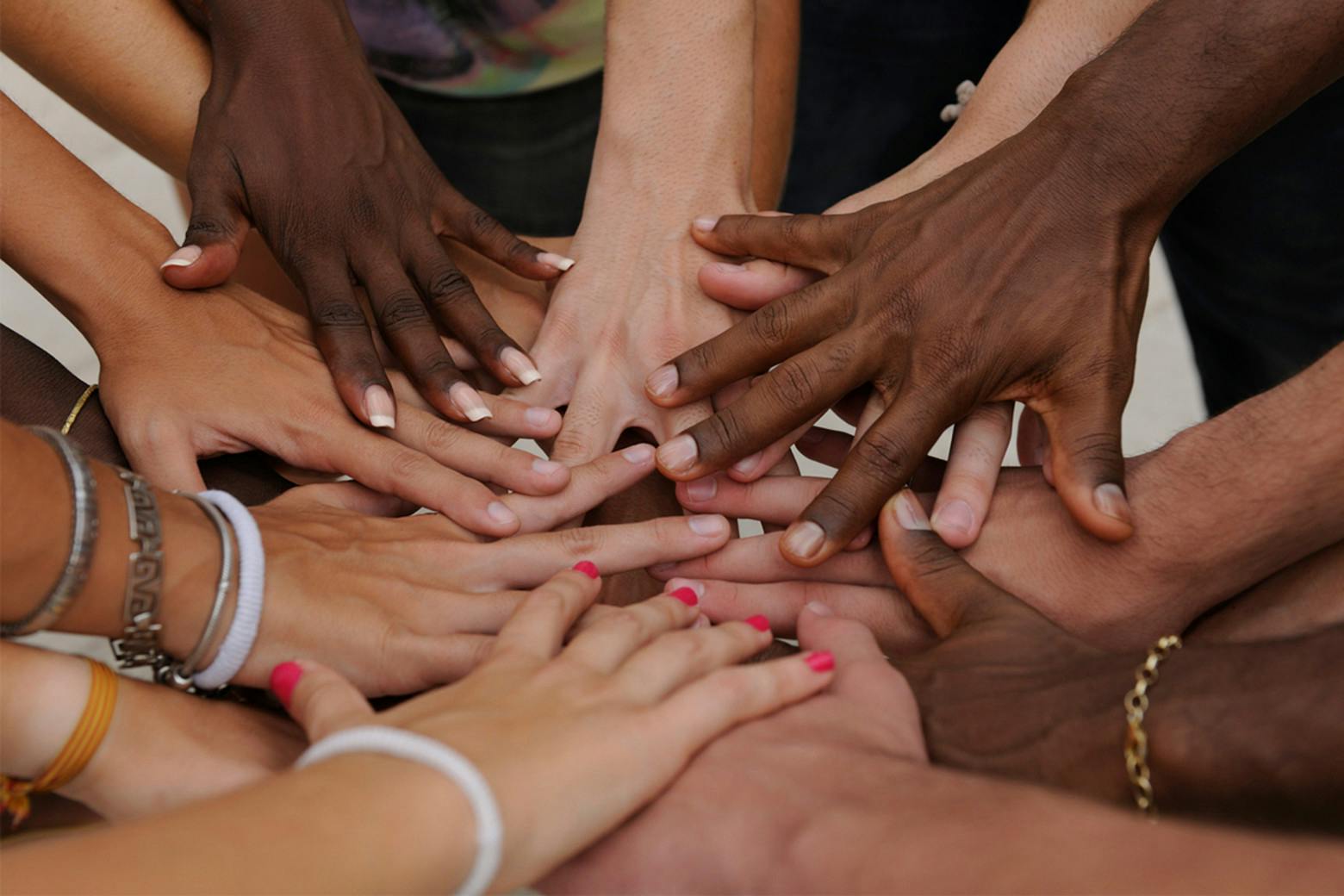 A photo of diverse women's hands to represent attention on Breast Cancer Awareness Month 2019 and AiRS Foundation Advocacy.