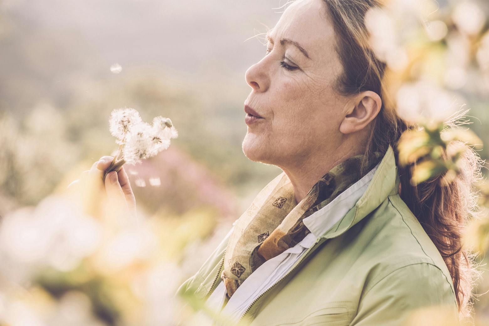 Photo of an Older Woman in Field As She Learns Symptoms of Menopause During World Menopause Awareness Month
