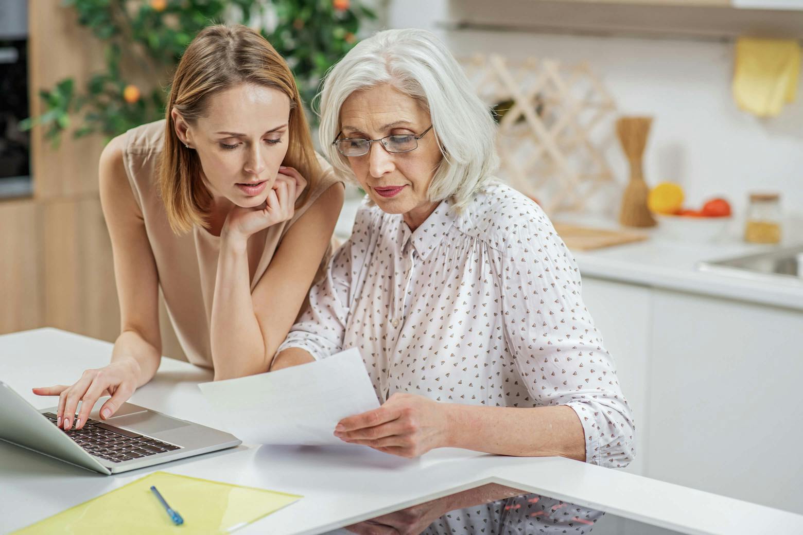 A photo of a mother and daughter researching where to report nursing home abuse.