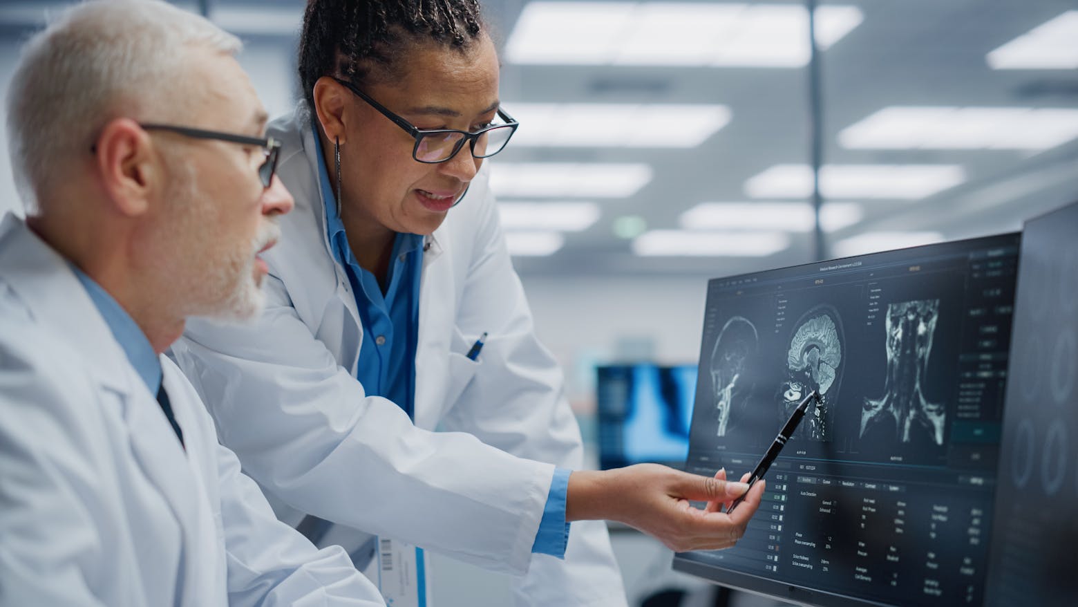 Doctors in neurology looking at a brain scan representing the Camp Lejeune Parkinson's risks.