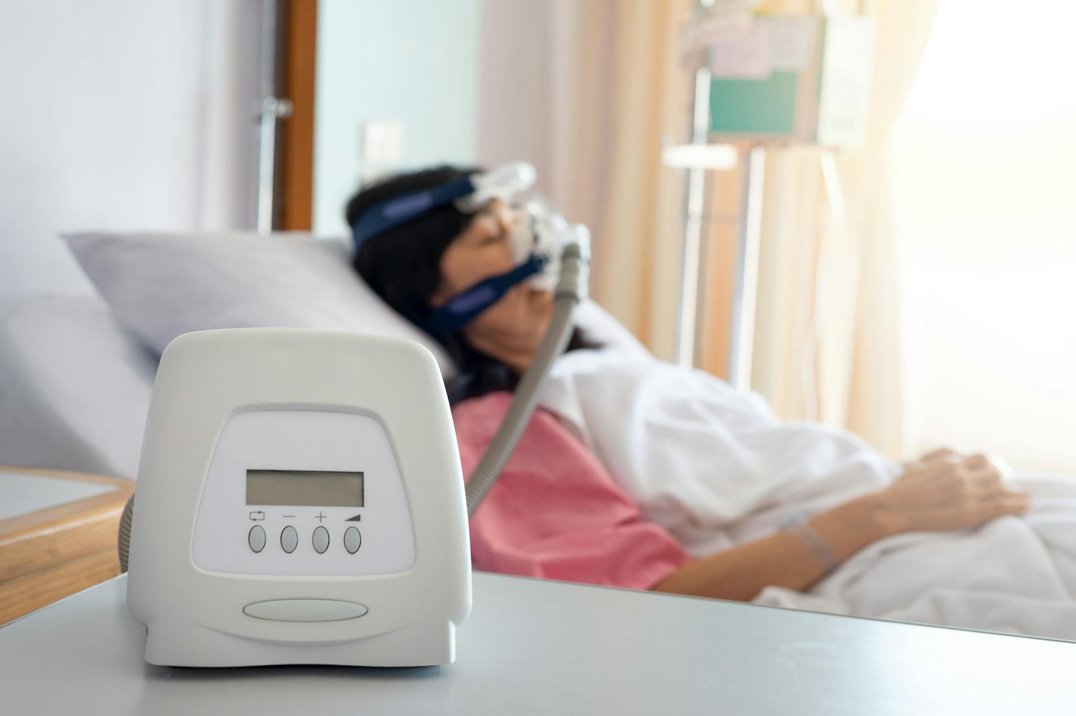 A woman on a CPAP machine representing the Philips CPAP settlement.
