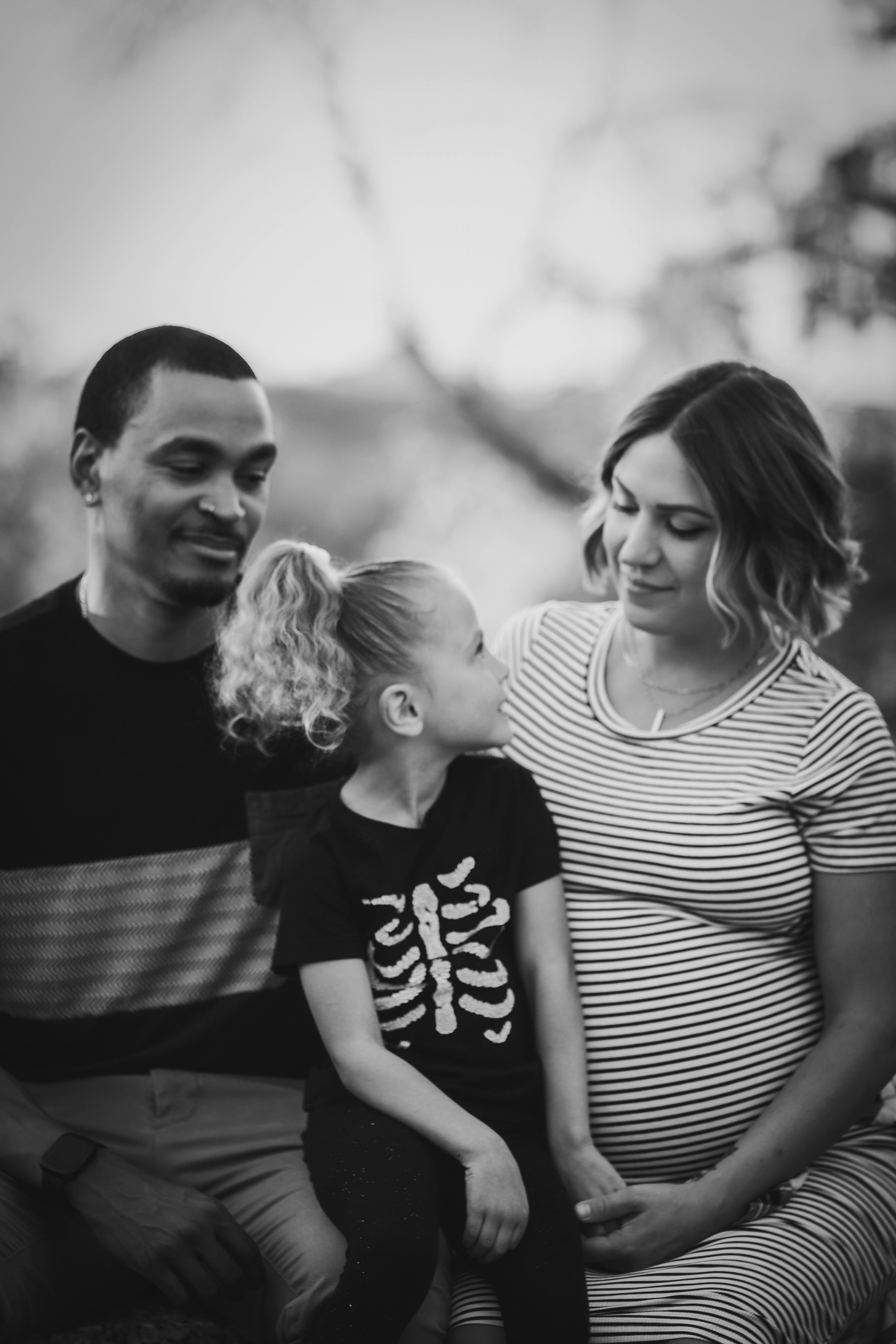 family of three staring at each other