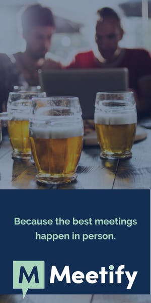 Two people grab drinks and meet up. The best meetings happen in person and are scheduled with Meetify.