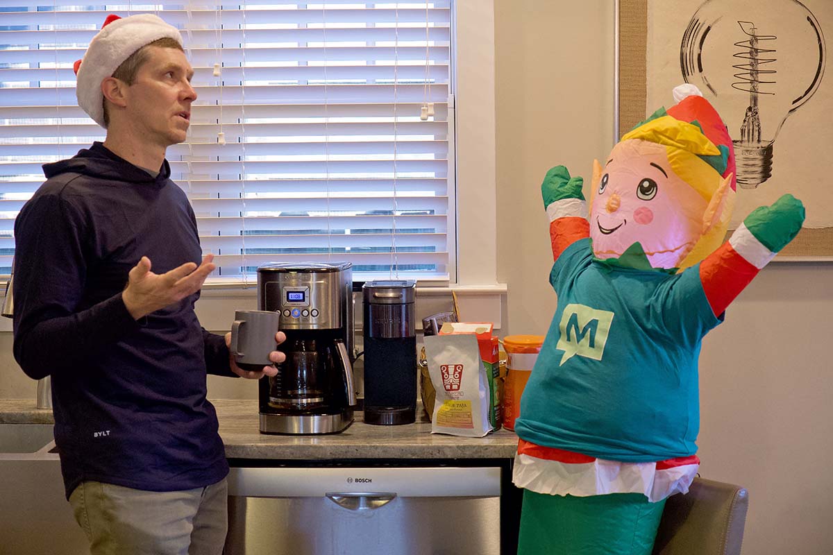 Meetify staff chat around the coffee machine.