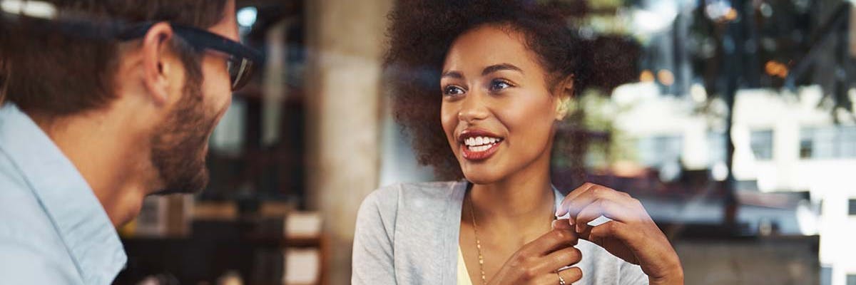 A man and woman meet for coffee to discuss a business project