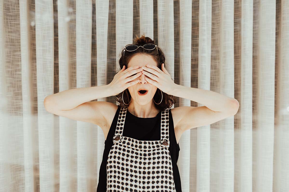 Surprised woman covering her eyes! (Brooke Cagel unsplash)