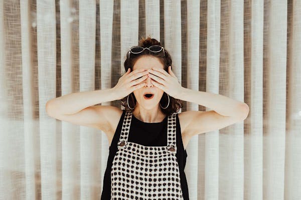 Surprised woman covering her eyes! (Brooke Cagel unsplash)