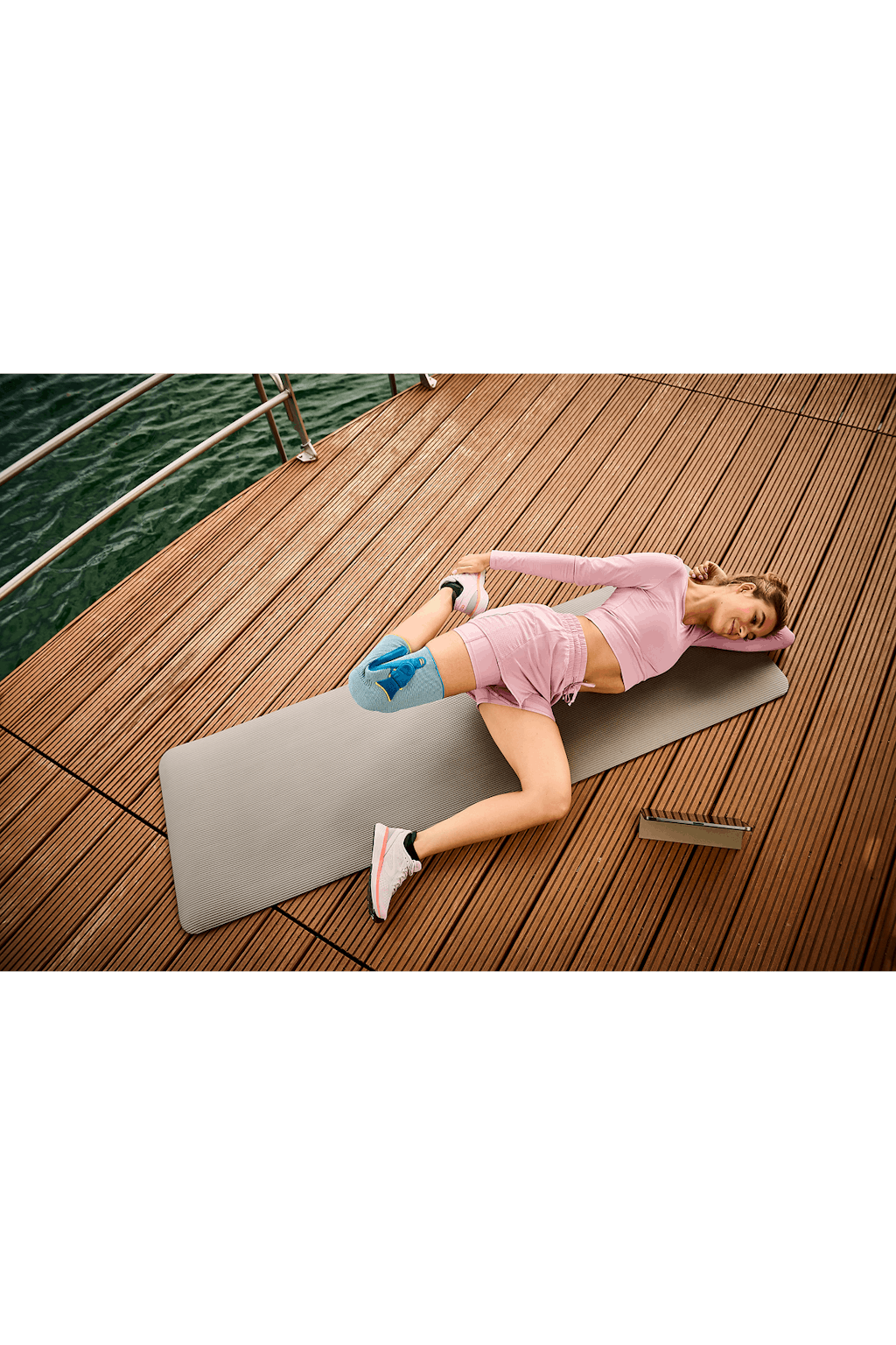 Frau macht Yoga mit Kniebandage