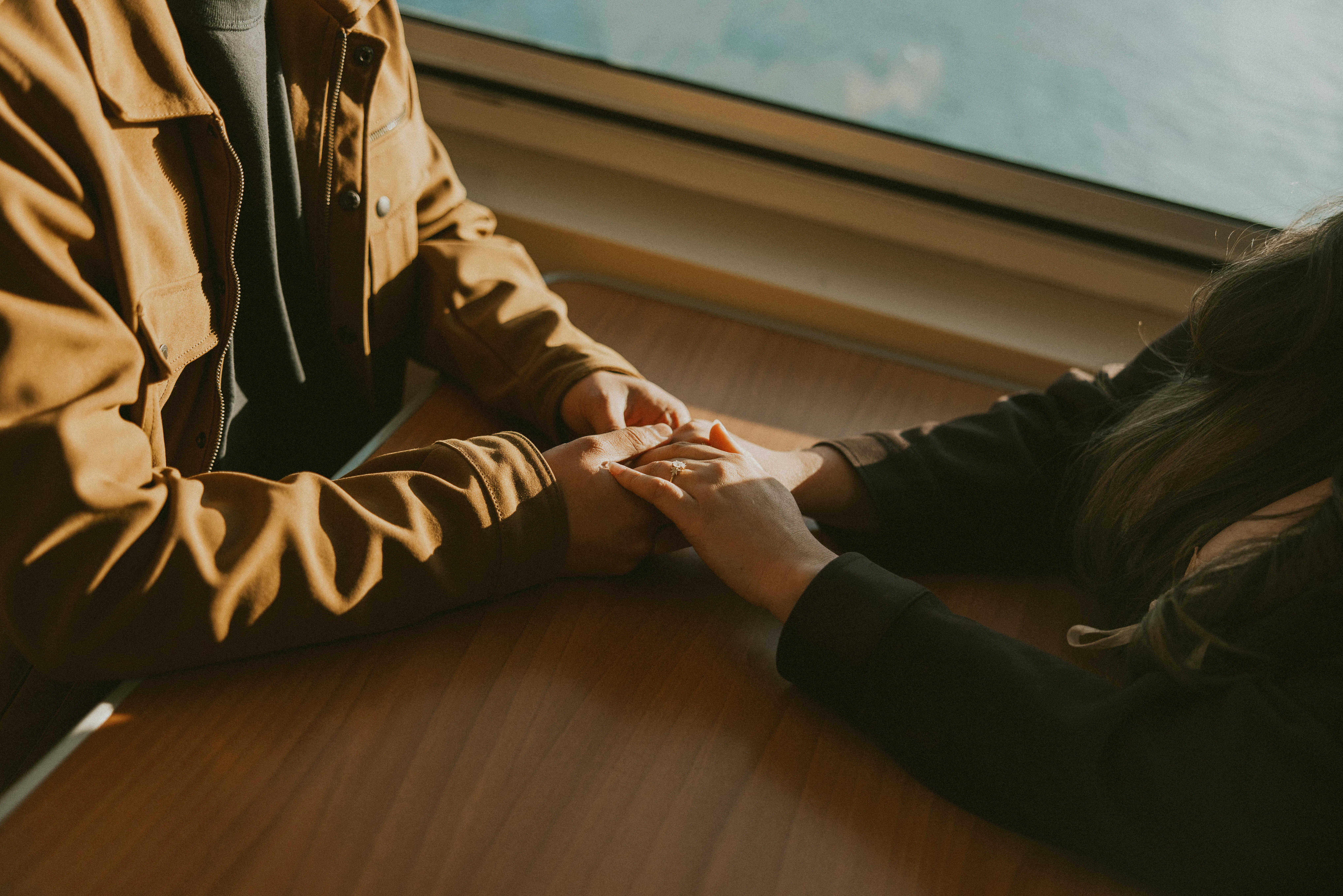 Seattle Couple holding hands at their engagement session on a ferry headed to San Juan Island