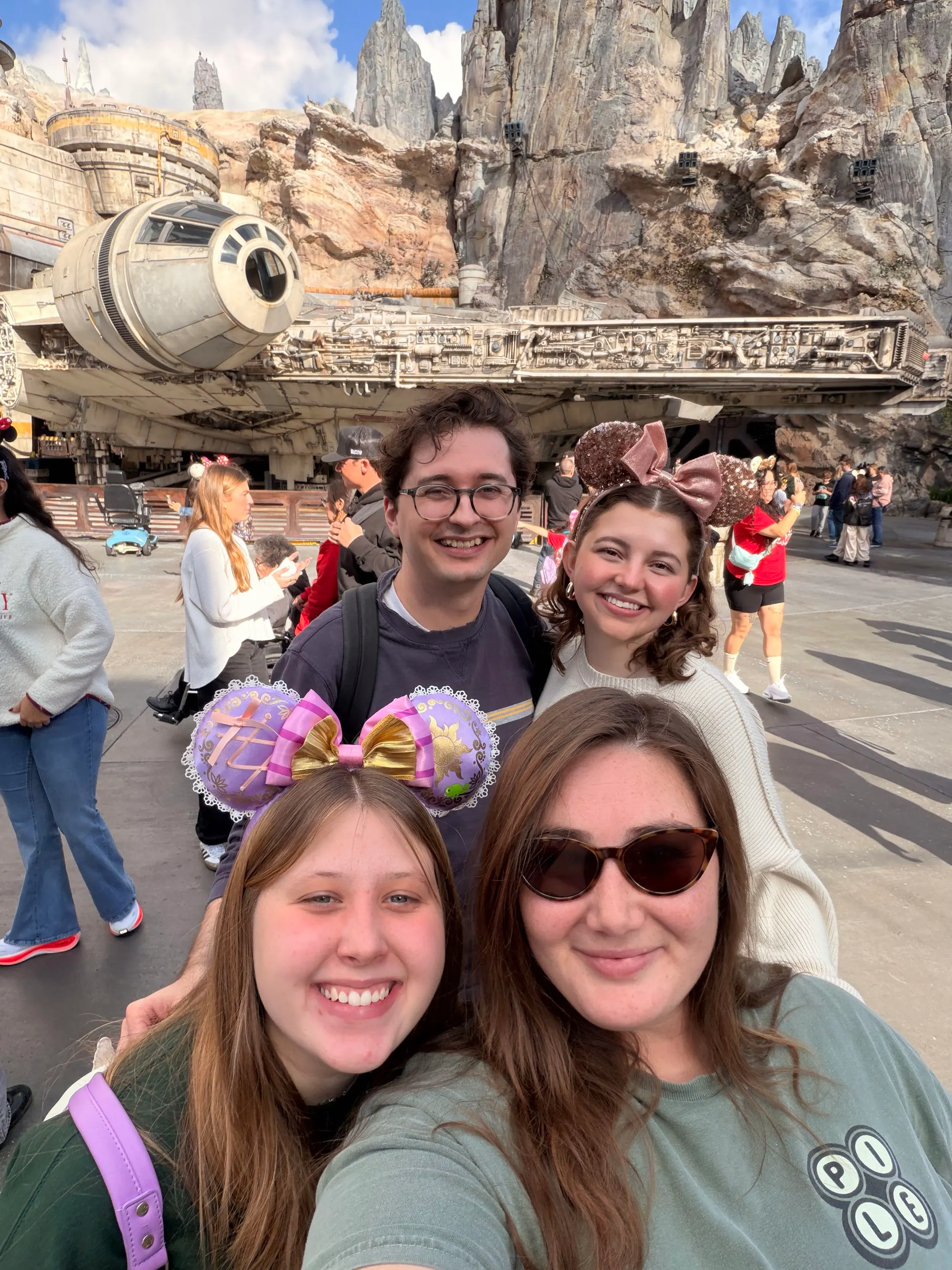 Meggy, her husband, and their sisters in Disneyland
