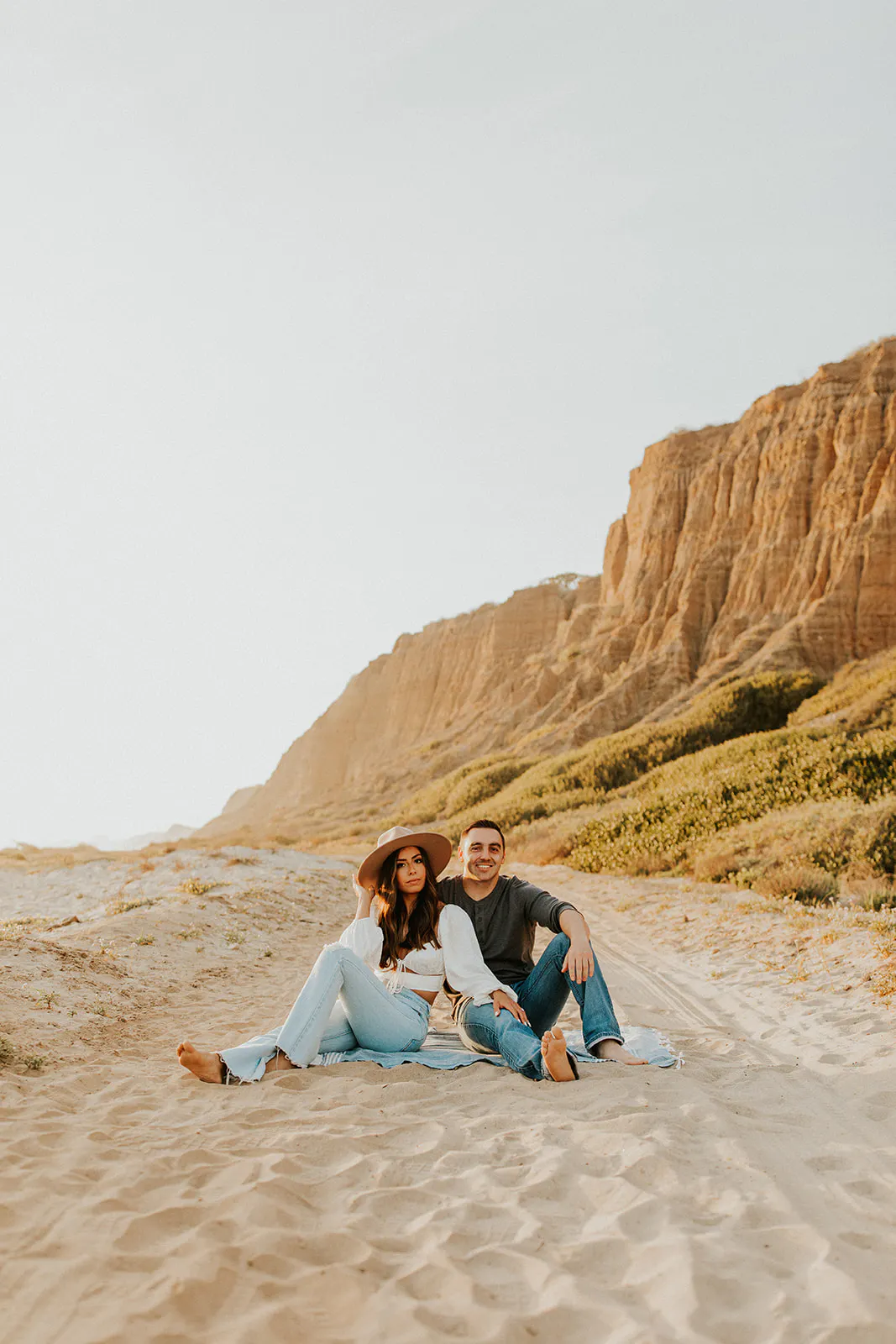 San Clemente Couple poses on a beach for engagement photos