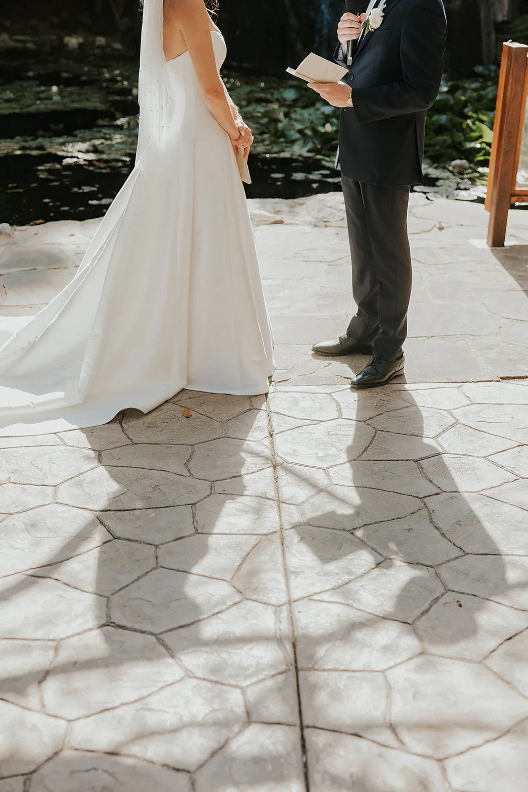 Shadow of bride and groom at their ceremony during their wedding day in oceanside 
