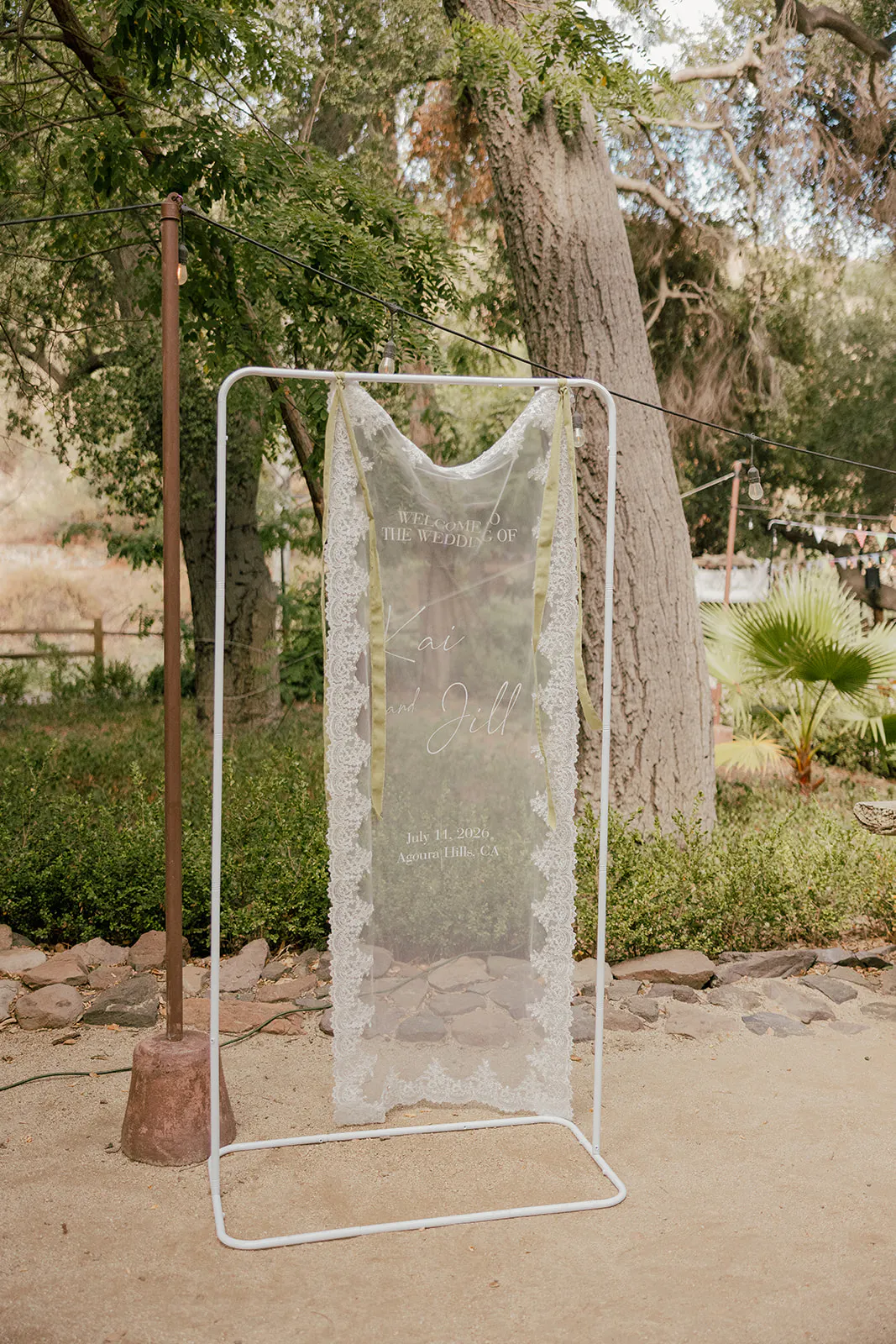 Lace Welcome Sign at Parent Trap meets Midsummer Nights wedding Inspo