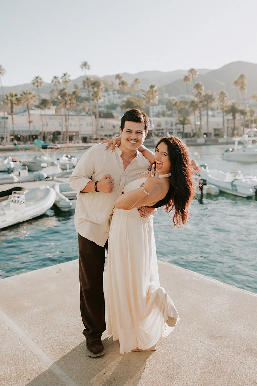 Couple who gets engaged on Catalina Island poses on a dock together