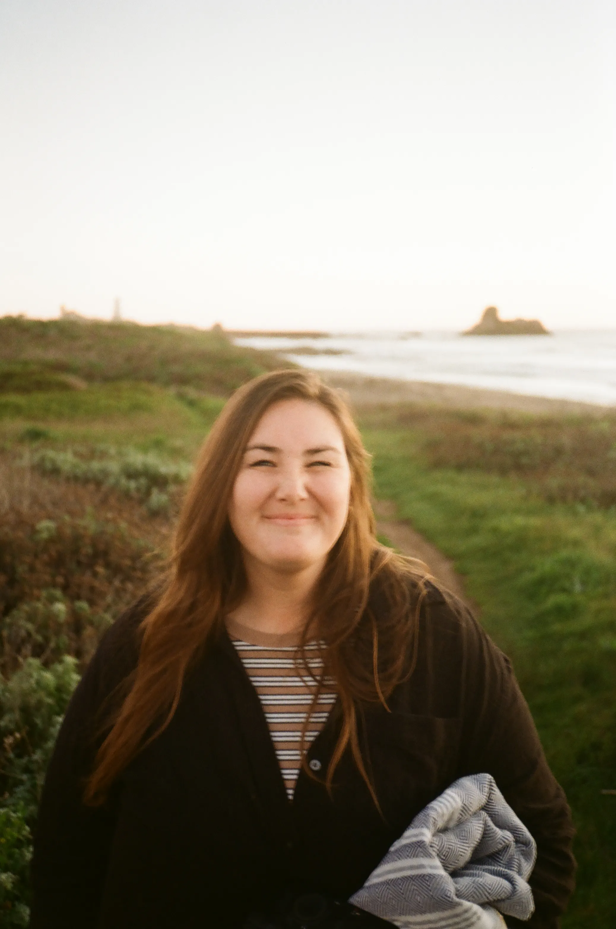 Meghan posing on the coast of cambria