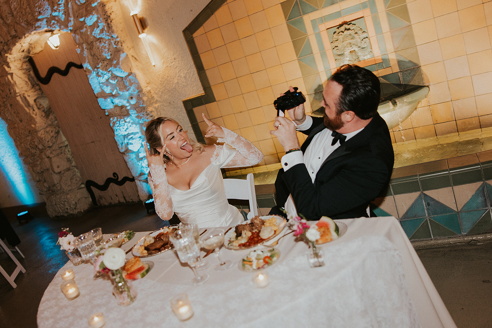 Couple photographing eachother at their wedding reception at the oviatt penthouse, los angeles