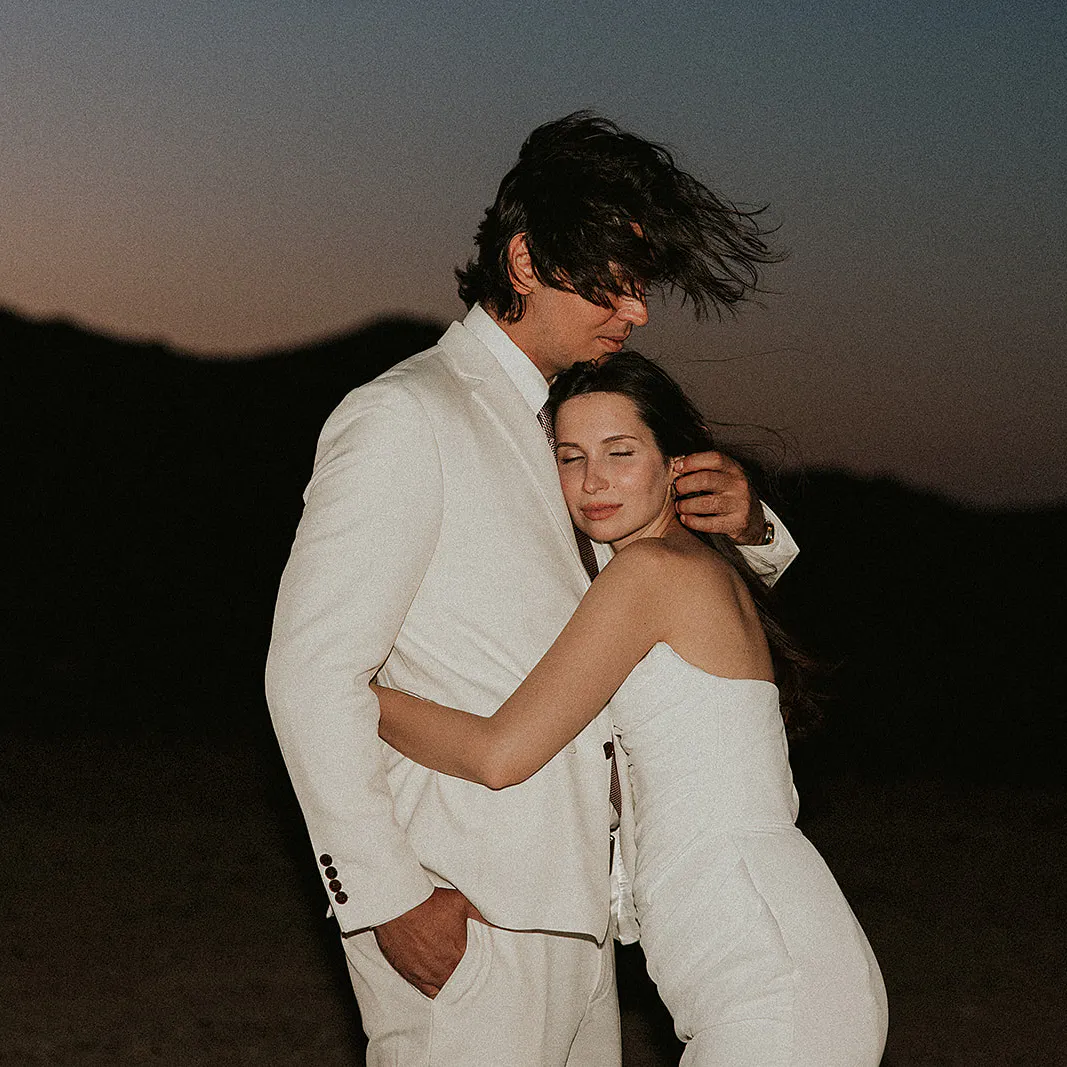 Joshua Tree Couple eloping in the desert embracing at sunset