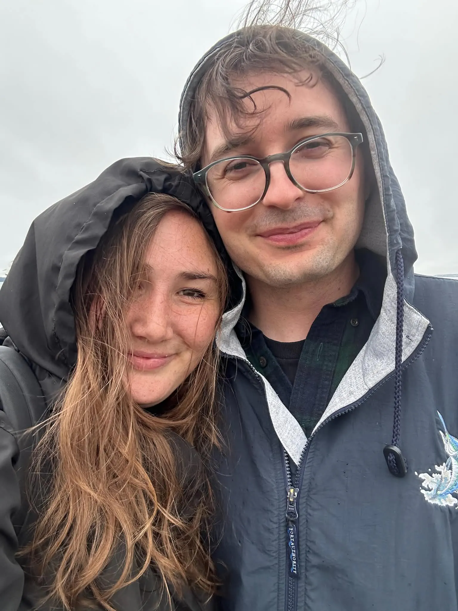 Husband and wife posing in rainy weather in Maine