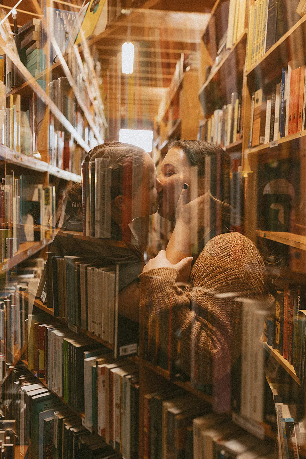 Lesbian lovers share a kiss in a bookstore in North Park in San Diego