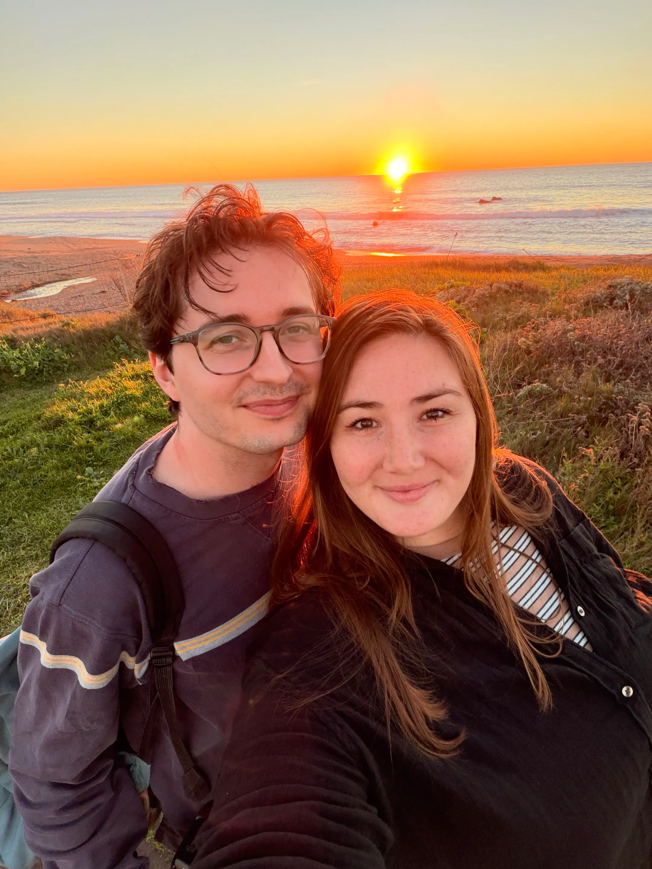 A couple posing on the coast of Cambria