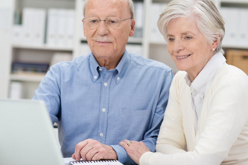couple de personnes âgées devant ordinateur