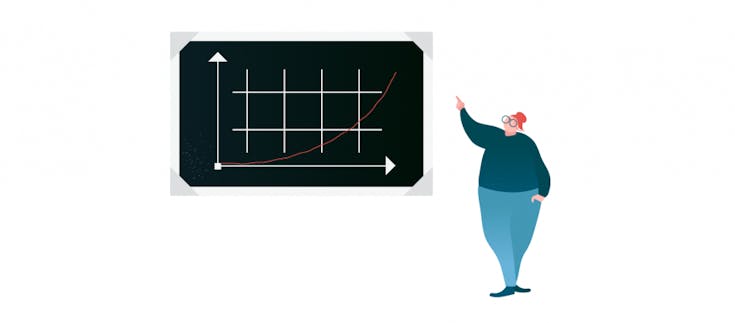 Auf dem Bild ist eine Frau zu sehen, die auf einen Graphen an einer Tafel zeigt