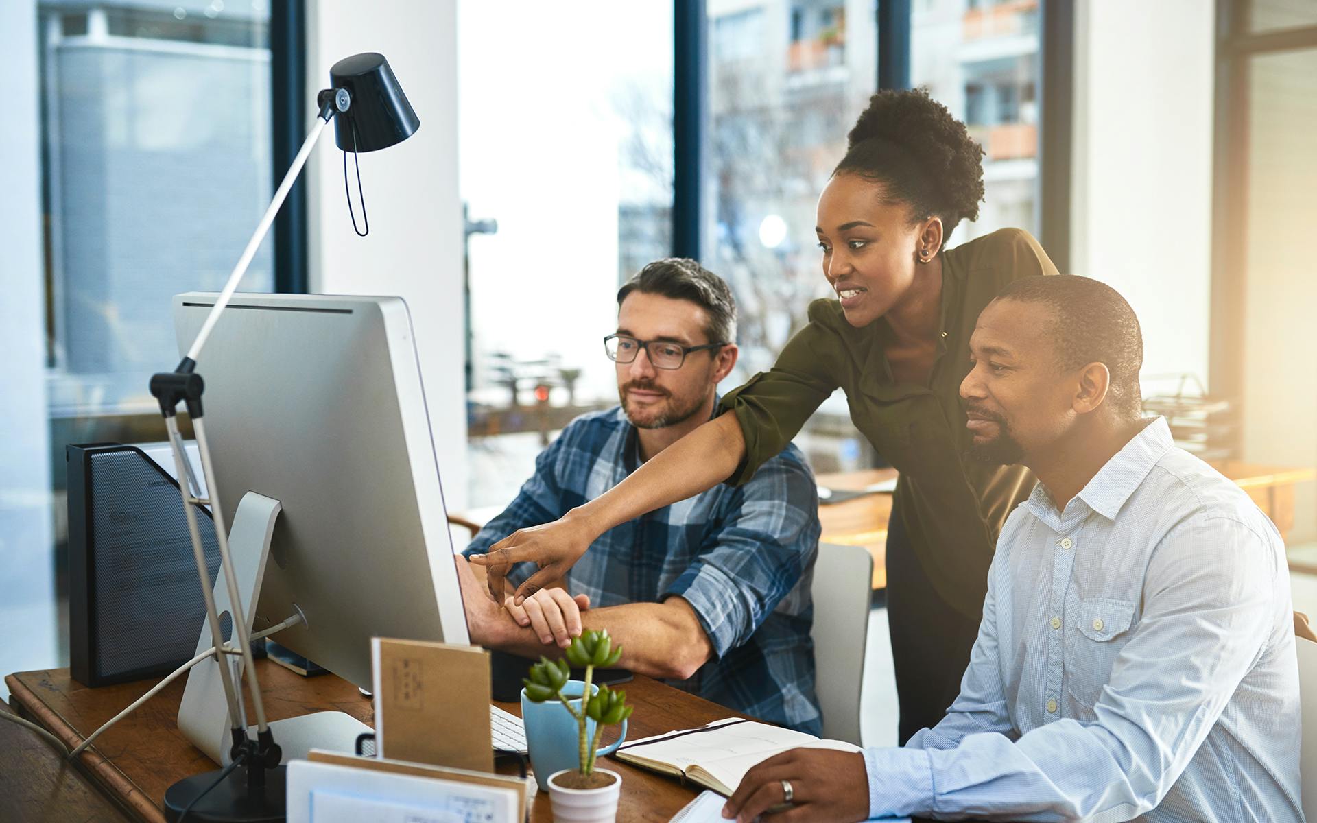 Marketing professionals looking at a computer screen. 