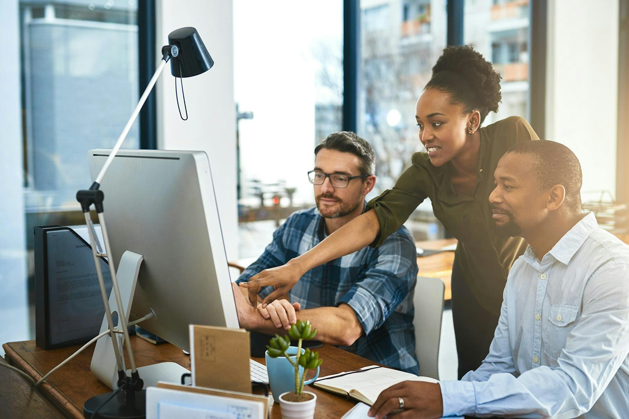 Marketing professionals looking at a computer screen.