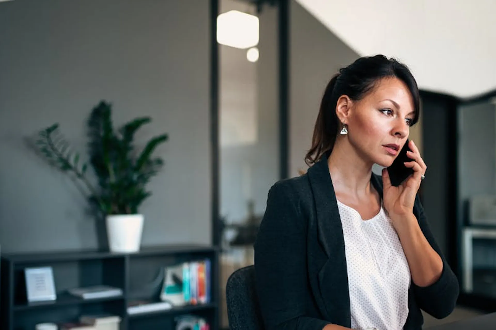 woman on the phone and looking at a computer screen