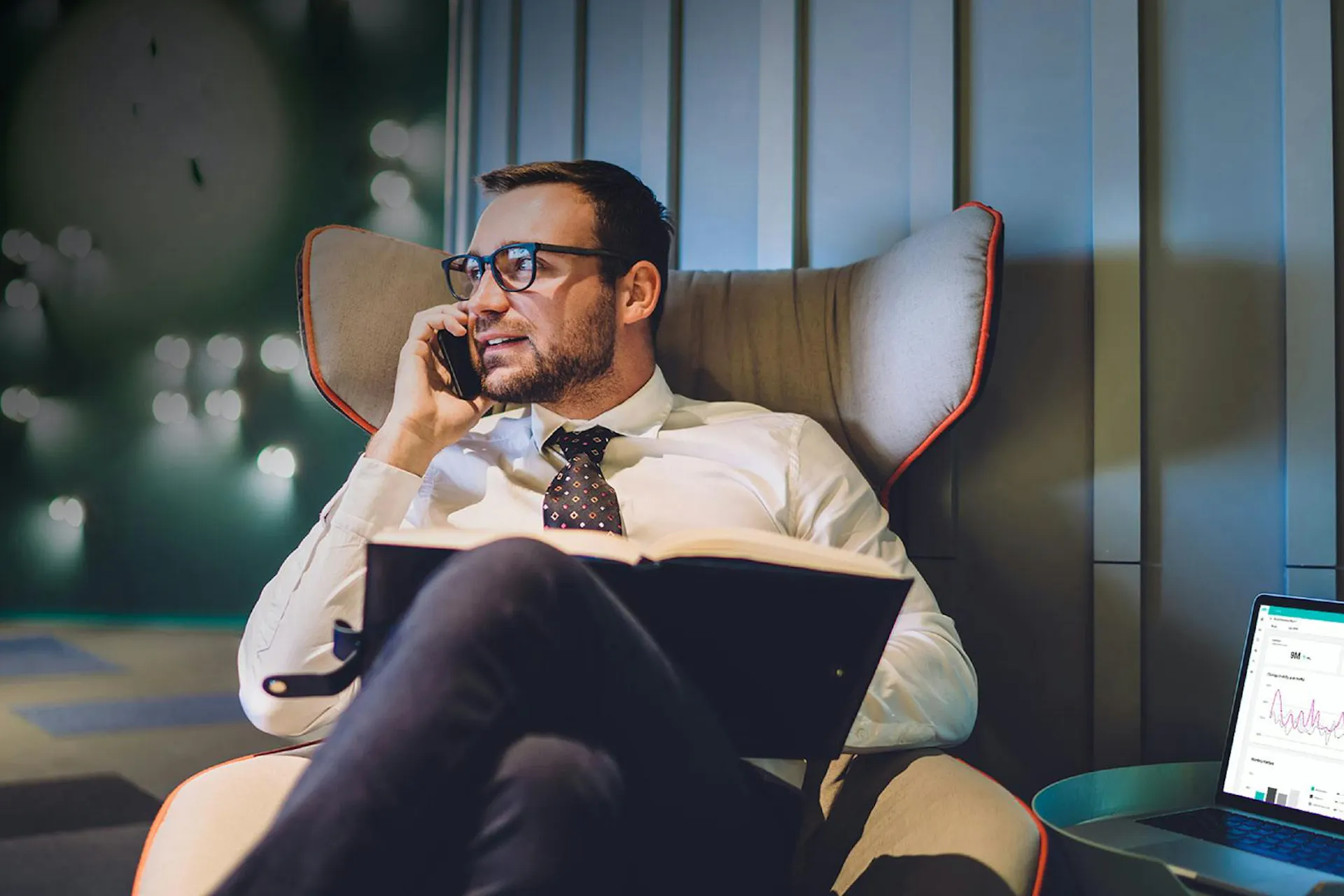 Photo of an executive in a chair working on his laptop