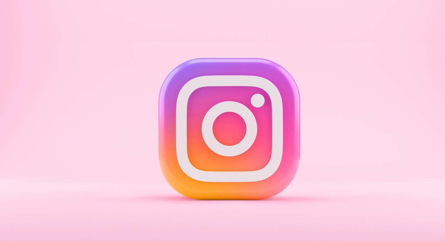 A giant Instagram logo with a pink background. This image is being used in a blog post announcing the release of scheduling and publishing for Instagram Stories and Carousel posts through Meltwater. 
