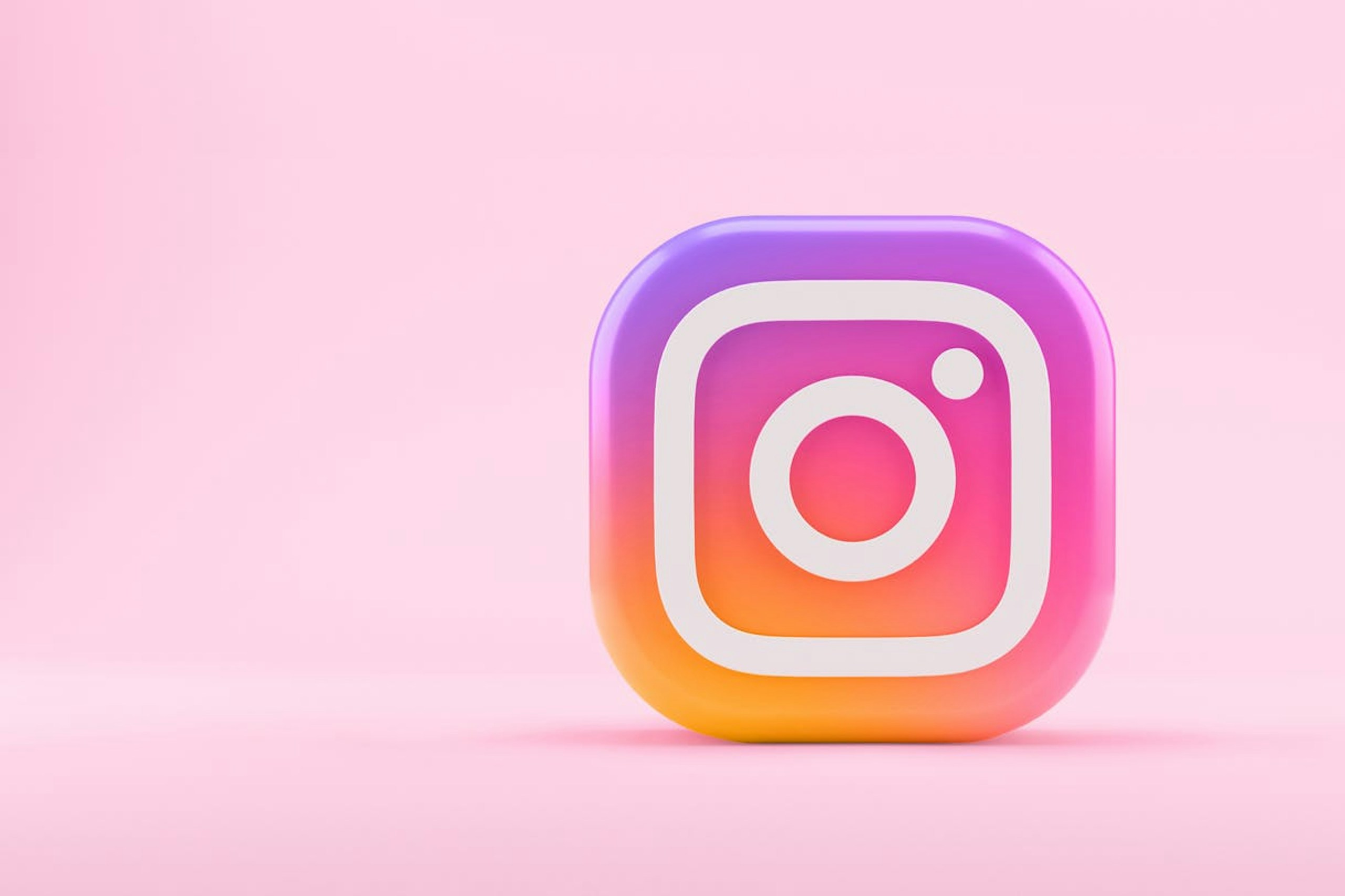 A giant Instagram logo with a pink background. This image is being used in a blog post announcing the release of scheduling and publishing for Instagram Stories and Carousel posts through Meltwater.