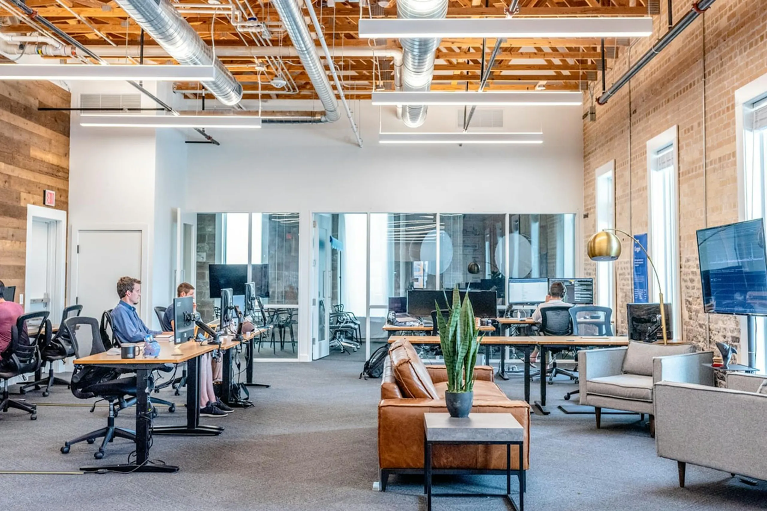 An open plan office with people working at their desks