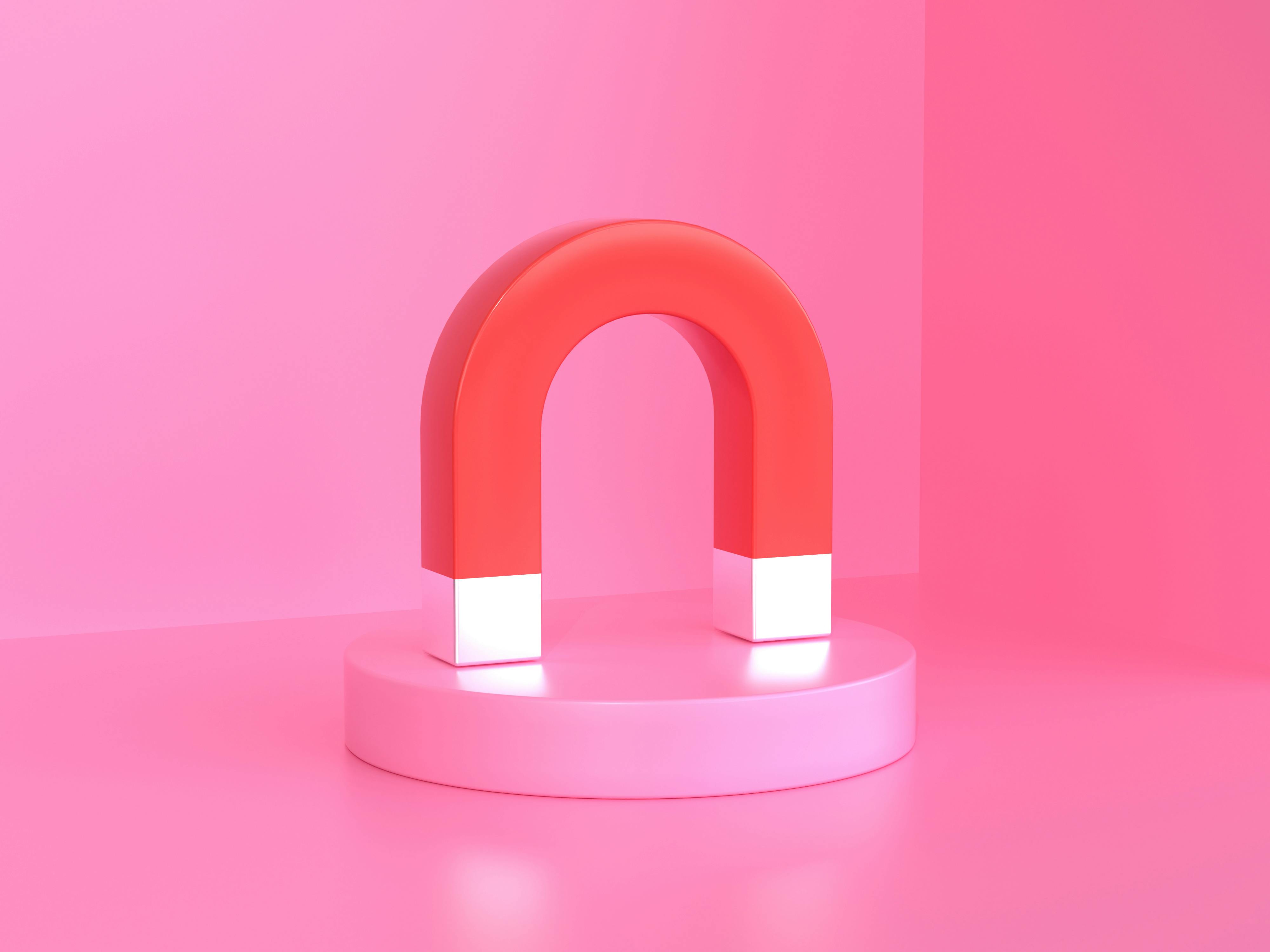 A pink magnet on a pink background