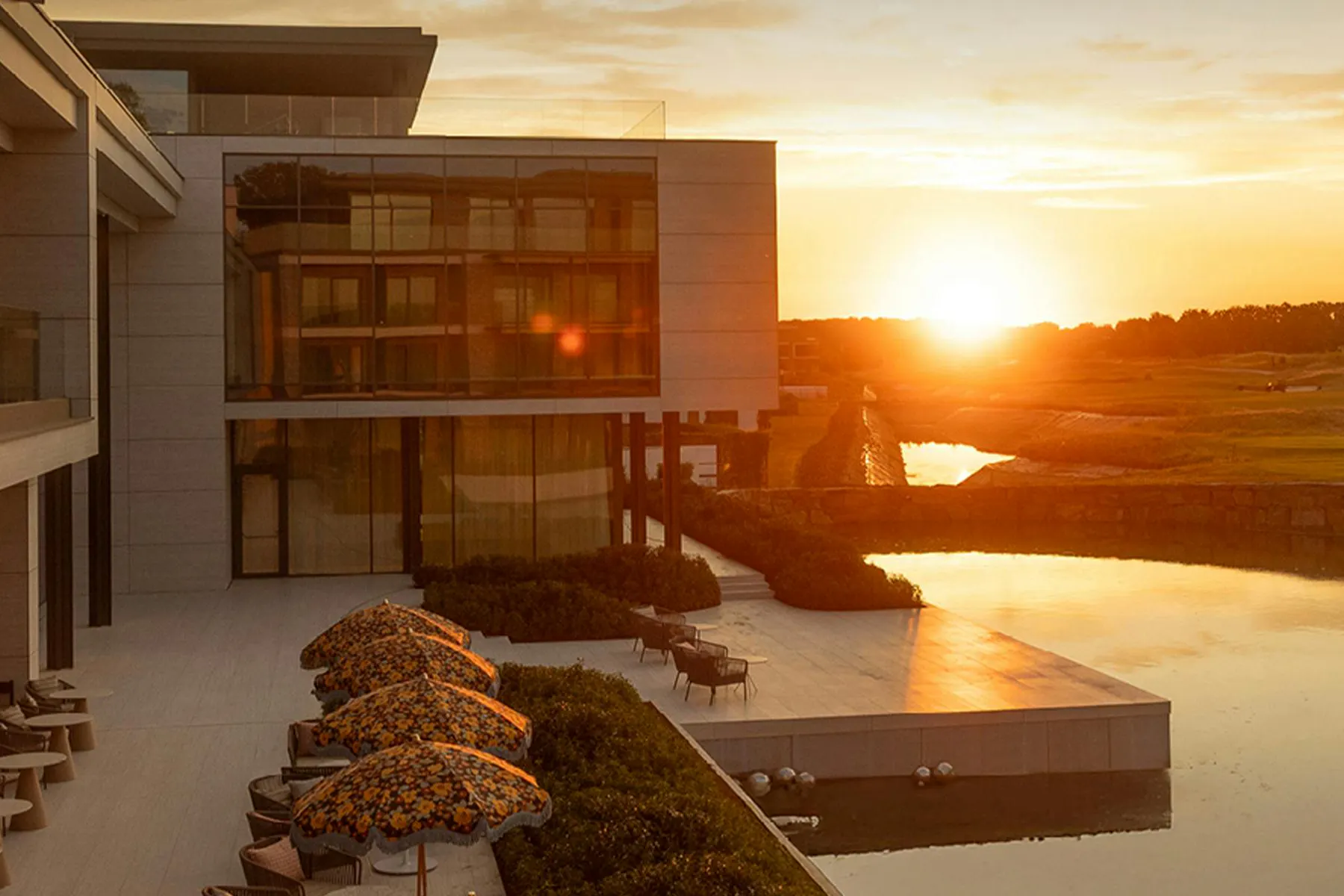 Une photo d'un coucher de soleil derrière un établissement de luxe du groupe Radisson Hotel Group doté d'une piscine à débordement, pour l'étude de cas Meltwater