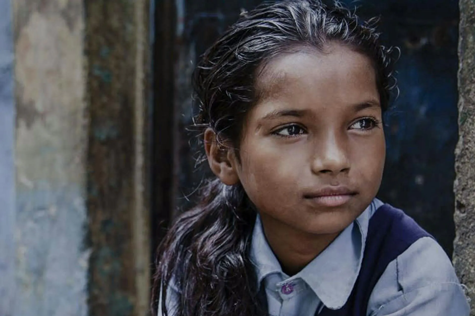 An image of a young girl looking into the distance