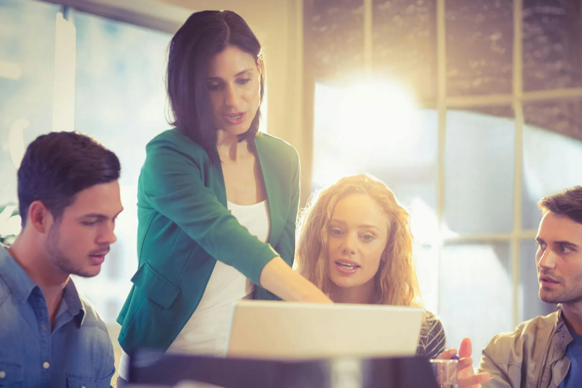 Photo of a woman showing her coworkers something