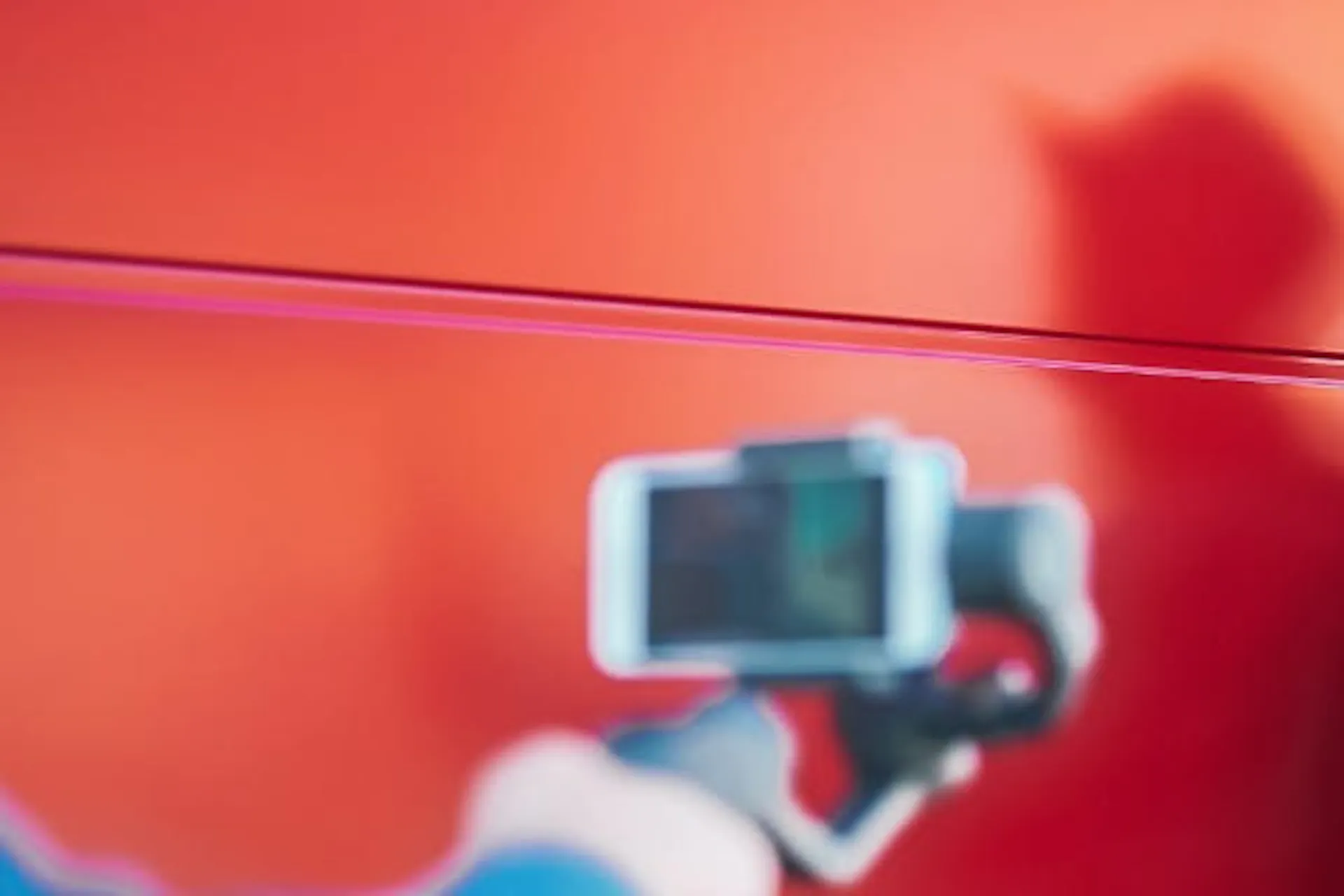 woman hearing a hat and smiling while taking a photo of herself