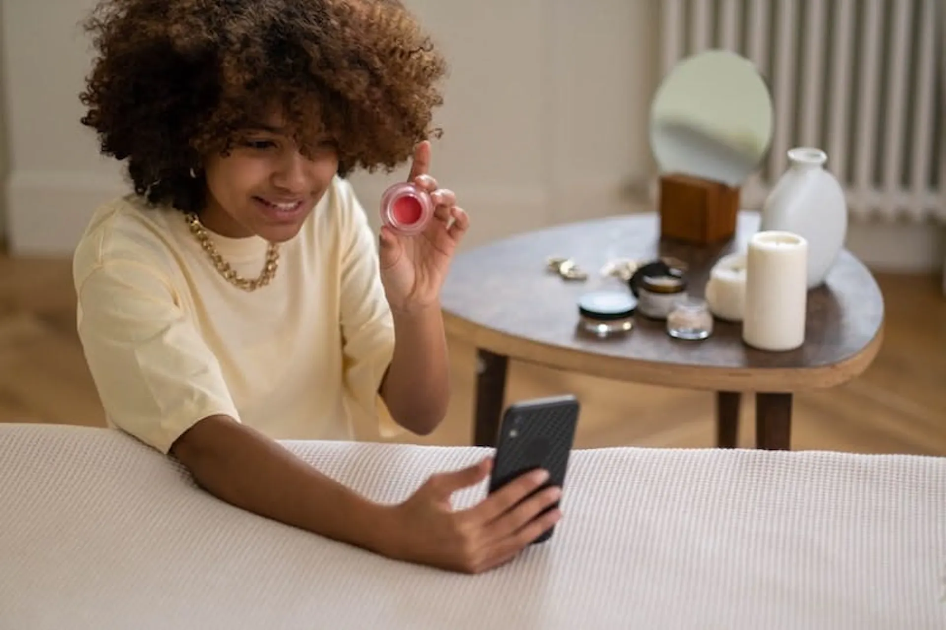 A young influencer is testing a lip gloss and promoting it via social media